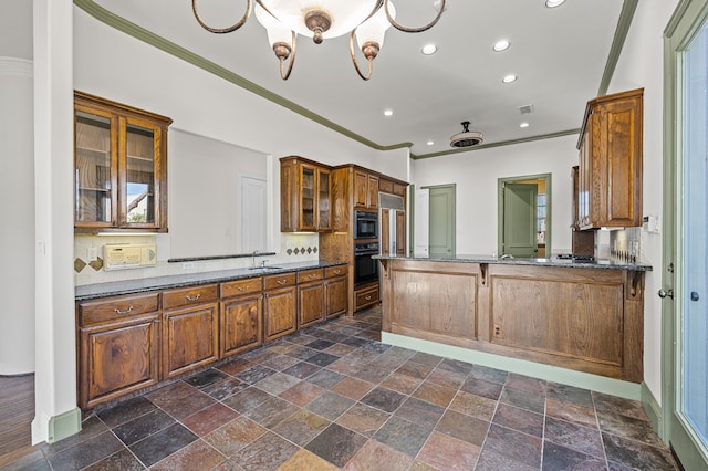 kitchen with oven, glass insert cabinets, tasteful backsplash, and crown molding