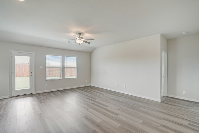 spare room featuring ceiling fan, light hardwood / wood-style floors, and vaulted ceiling