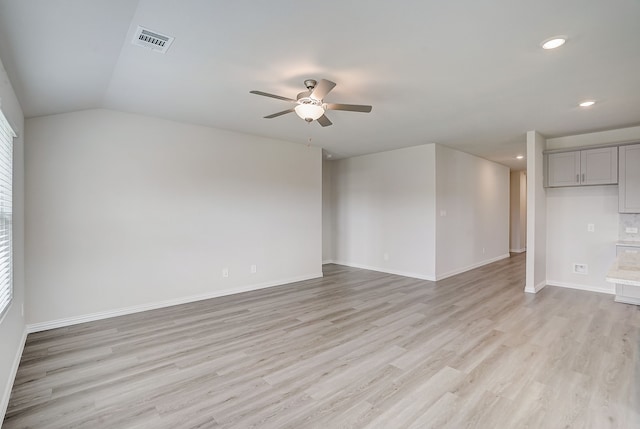 unfurnished room featuring ceiling fan, vaulted ceiling, and light hardwood / wood-style flooring