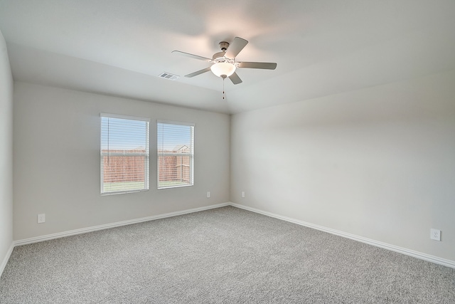 empty room featuring carpet flooring and ceiling fan