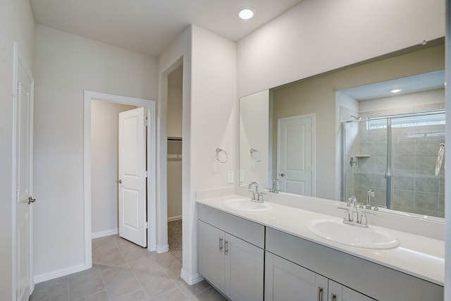 bathroom featuring tile patterned flooring, vanity, and walk in shower