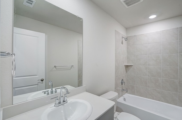 full bathroom featuring vanity, toilet, and tiled shower / bath