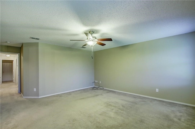 spare room with light carpet, a textured ceiling, and ceiling fan