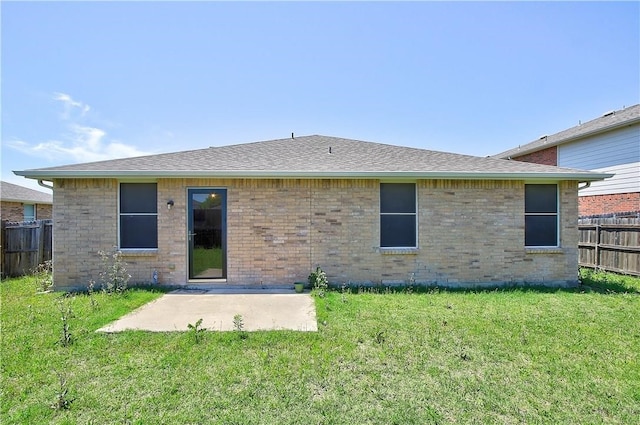 back of house featuring a lawn and a patio area