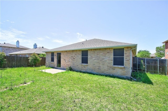 rear view of house featuring a lawn