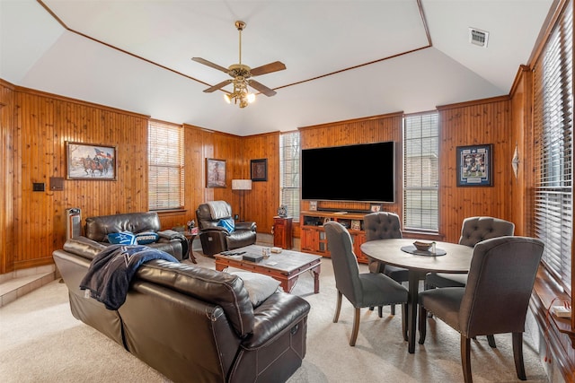 living room with light carpet, ceiling fan, wooden walls, and lofted ceiling