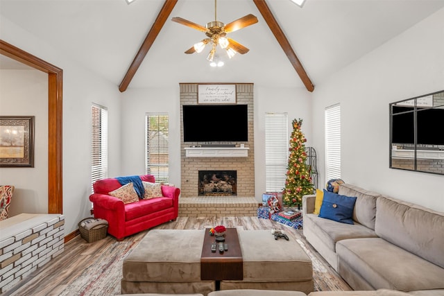 living room featuring light wood-type flooring, beamed ceiling, high vaulted ceiling, and a brick fireplace