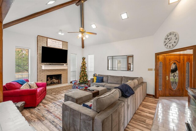 living room with high vaulted ceiling, hardwood / wood-style flooring, beamed ceiling, and ceiling fan with notable chandelier