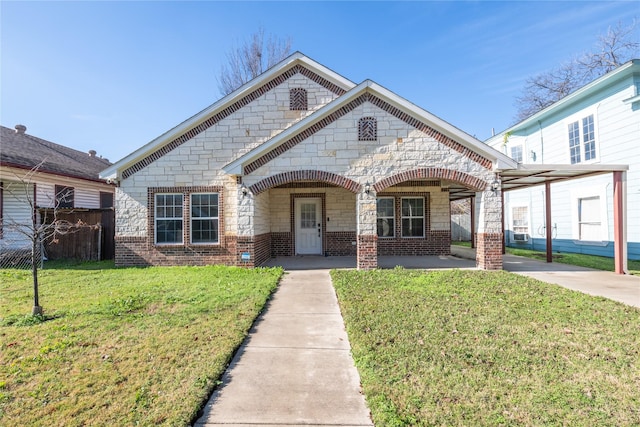 view of front of home with a carport and a front lawn