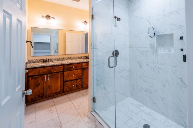 bathroom with vanity and a shower with door