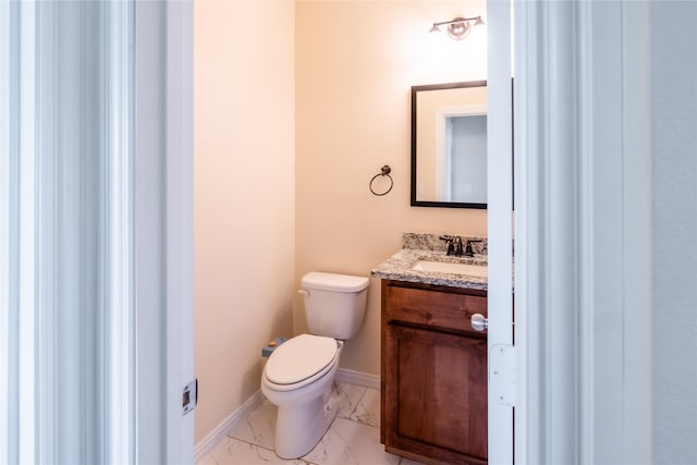 bathroom with toilet and vanity