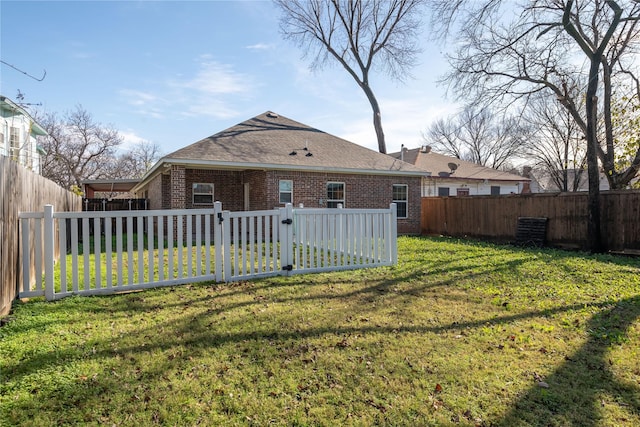 back of property featuring a yard