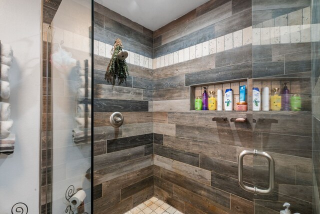 bathroom with a shower with door