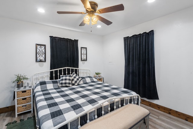 bedroom featuring hardwood / wood-style floors and ceiling fan