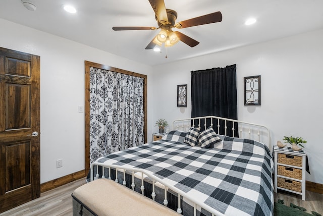 bedroom with ceiling fan and light hardwood / wood-style flooring