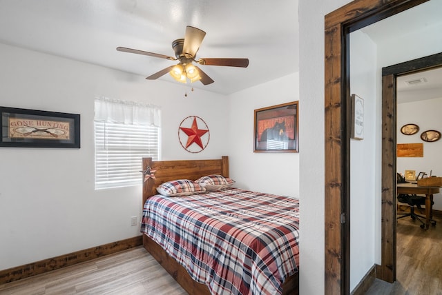 bedroom with ceiling fan and light hardwood / wood-style flooring