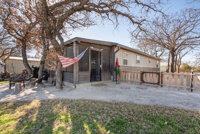 rear view of property with a sunroom