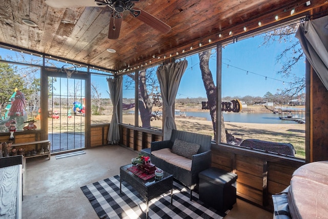 sunroom featuring a water view, ceiling fan, and wood ceiling