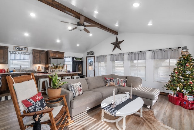 living room with vaulted ceiling with beams, hardwood / wood-style flooring, and ceiling fan