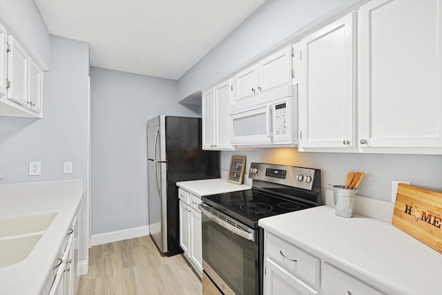 kitchen featuring light hardwood / wood-style flooring, white cabinetry, stainless steel range with electric cooktop, and sink