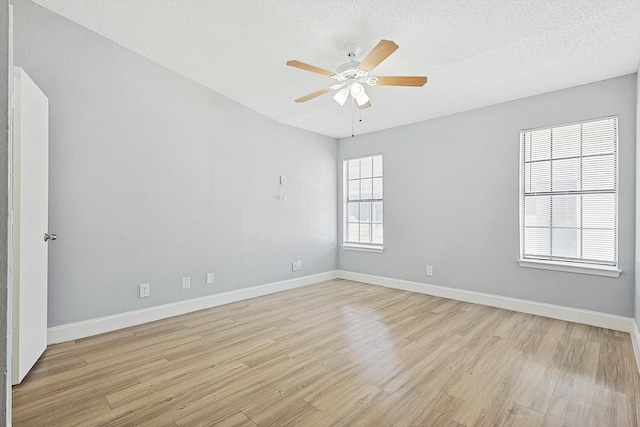 spare room featuring a textured ceiling, light hardwood / wood-style floors, and ceiling fan