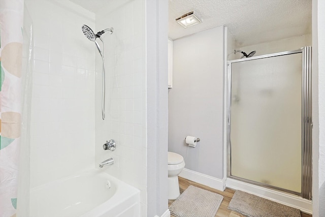 bathroom with separate shower and tub, wood-type flooring, a textured ceiling, and toilet