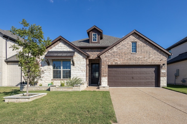 view of front of house with a front yard and a garage