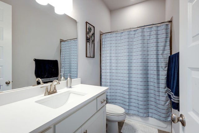 full bathroom with vanity, shower / tub combo, and toilet