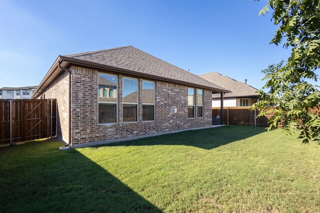 back of house with a lawn