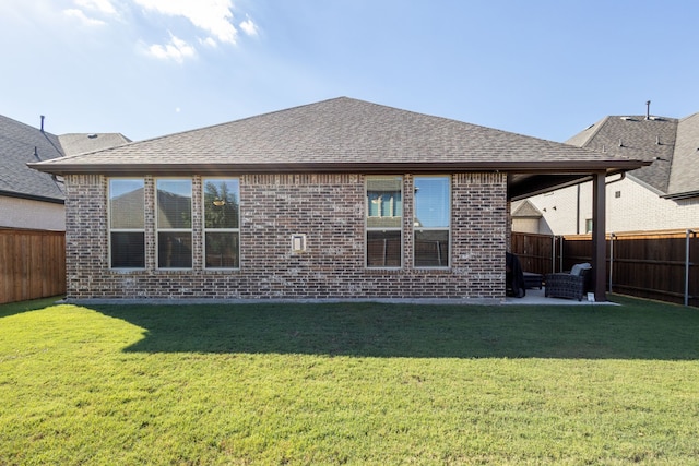 rear view of house with a patio area and a lawn