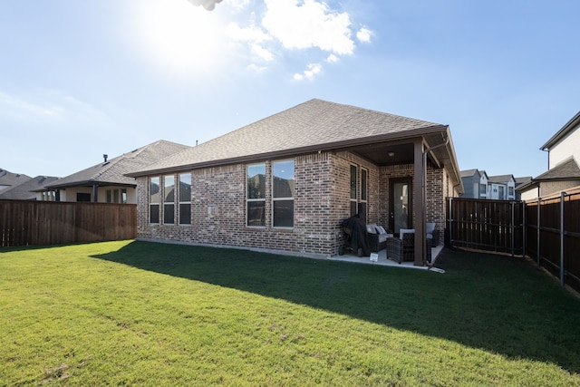 back of house featuring a yard and a patio area