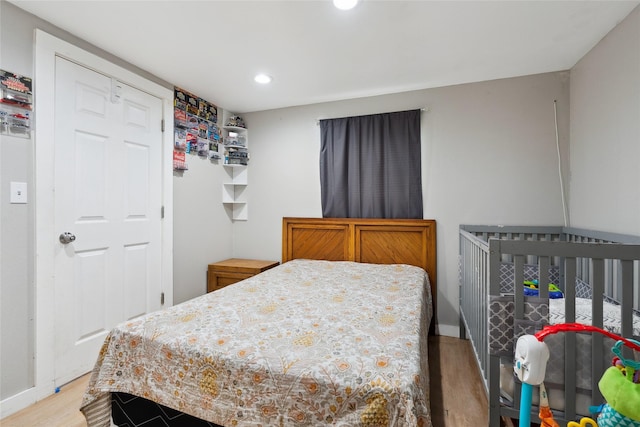 bedroom featuring hardwood / wood-style flooring and a closet