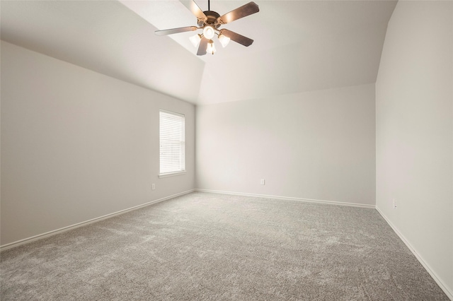 spare room featuring carpet, ceiling fan, and vaulted ceiling