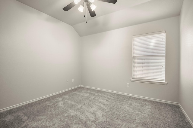 carpeted empty room featuring ceiling fan and vaulted ceiling