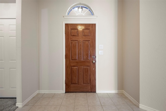 foyer entrance with light tile patterned floors