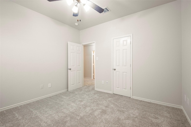 unfurnished bedroom featuring light colored carpet and ceiling fan