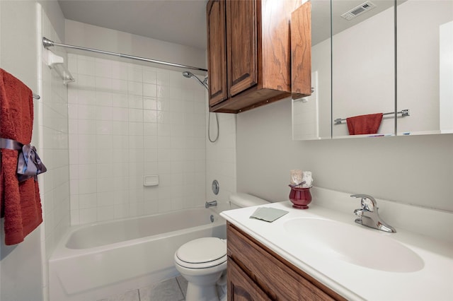 full bathroom featuring tile patterned flooring, vanity, toilet, and tiled shower / bath