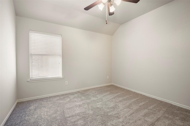 carpeted spare room with ceiling fan and lofted ceiling