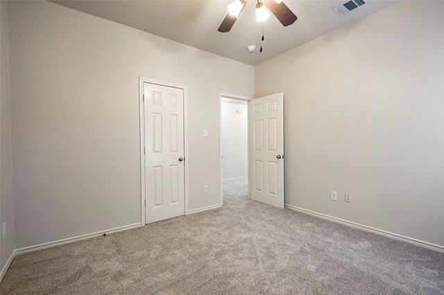 unfurnished bedroom featuring ceiling fan and light carpet