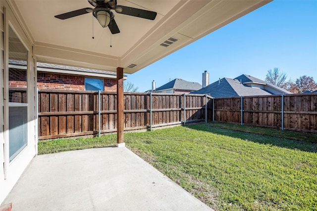 view of yard featuring ceiling fan and a patio