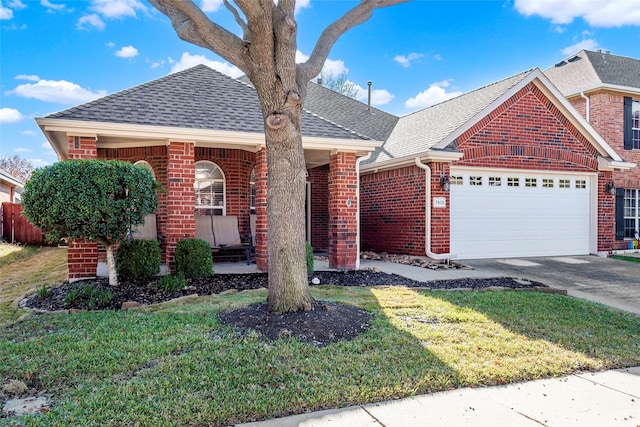 view of front of property with a front yard and a garage