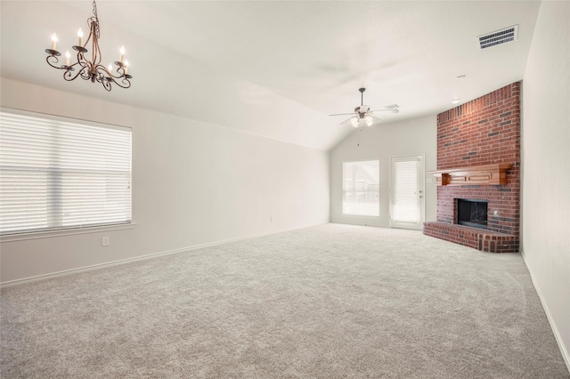 unfurnished living room featuring carpet, ceiling fan with notable chandelier, lofted ceiling, and a brick fireplace