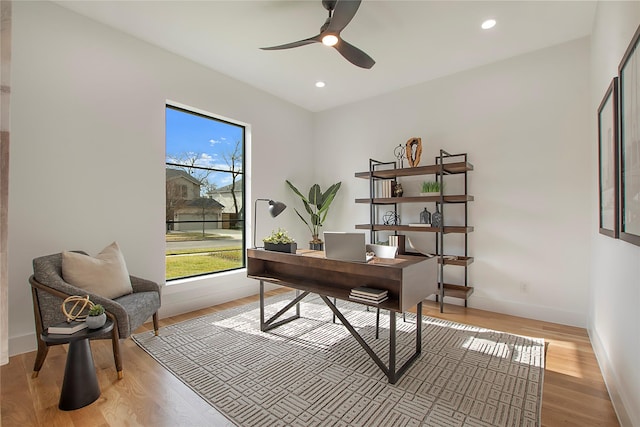 home office featuring light hardwood / wood-style flooring and ceiling fan