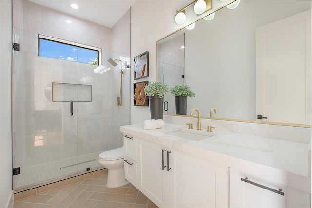 bathroom with tile patterned flooring, vanity, toilet, and a shower with shower door