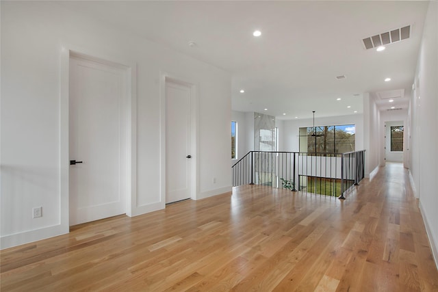 unfurnished room featuring plenty of natural light and light hardwood / wood-style floors