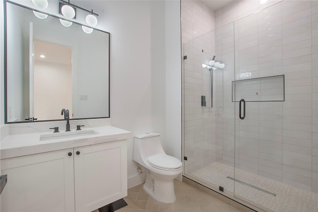 bathroom featuring tile patterned floors, vanity, toilet, and a shower with door