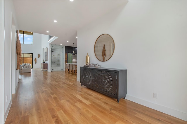 hallway with light hardwood / wood-style floors