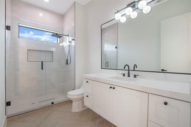 bathroom featuring tile patterned flooring, vanity, toilet, and walk in shower