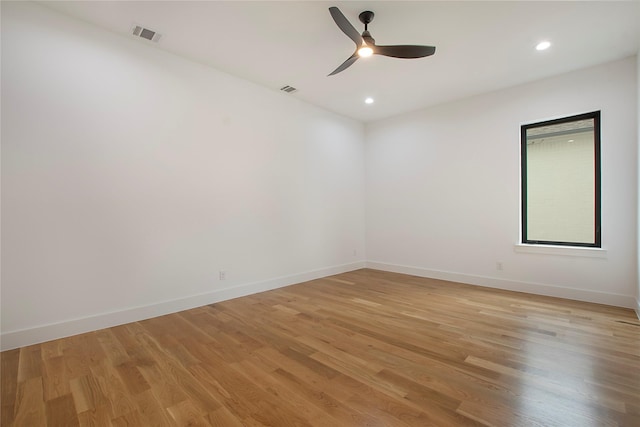 unfurnished room with light wood-type flooring and ceiling fan