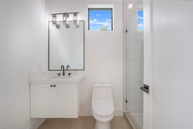 bathroom with tile patterned flooring, vanity, toilet, and a shower with door